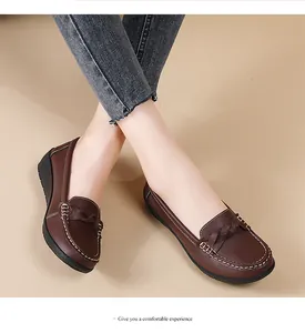 Macro view of brown casual loafers featuring braided detail and white stitching