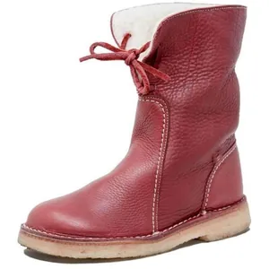 Close-up of stylish red leather mid-calf snow boots with warm faux-fur lining and top laces.