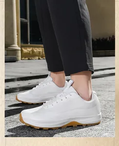 Close-up of men's low-top white mesh outdoor hiking shoes shown on stone pavement