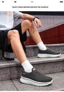 Close-up of breathable grey slip-on walking sneakers for men and women on stairs.