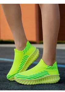 Close-up of vibrant neon green flyknit slip-on sneakers for athletic running and walking