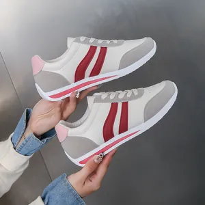 Women's casual lace-up sports shoes with red stripes and grey suede accents on white base