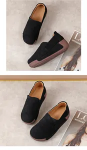 Macro view of comfortable black suede leather rocker shoes with thick brown platform soles
