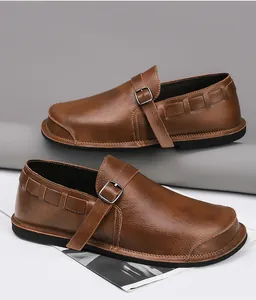 Detailed view of handmade vintage brown leather wide-toe men's casual loafers with buckle