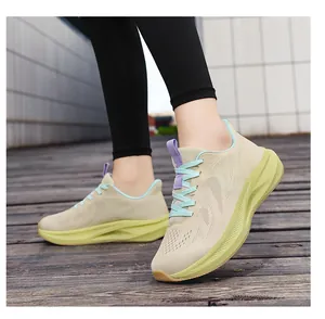 Close-up of women's fly-knit running shoes with lime green thick soles on wooden deck