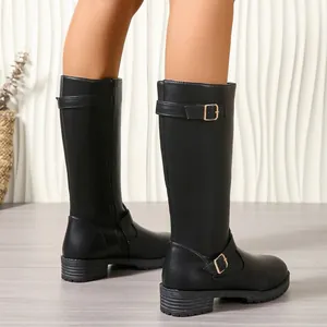 Close-up rear view of black leather knee-high rider boots featuring stylish buckle details