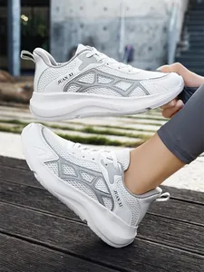 Close-up of white breathable running shoes with grey accents showing side design and fit