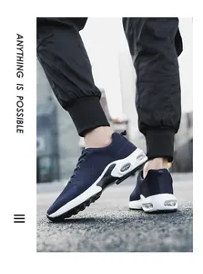 Side view of navy blue fly-knit men's sneakers with visible air cushion in white sole