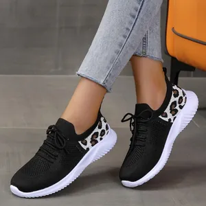 Women's stylish black mesh sneakers featuring leopard print accents and wavy white soles