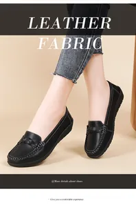 Close-up of black leather casual flat loafers with woven detail and textured finish