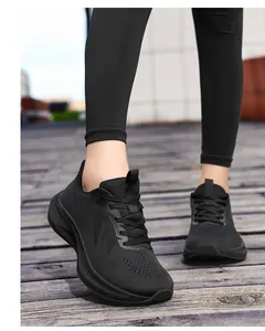 Close-up of black breathable knit running shoes for women in an outdoor setting