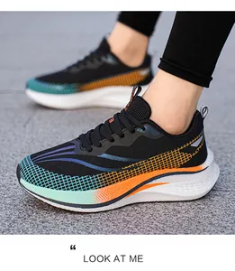 Side view of black unisex running shoes with colorful gradient mesh on outdoor pavement