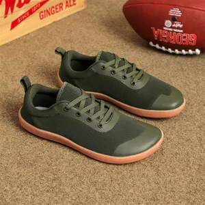 Detailed macro view of the breathable dark green knit mesh on wide-toe barefoot sneakers.