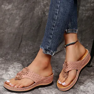 Detailansicht der rosa Keilsandalen mit Blumenmuster und Plateausohle für Damen.