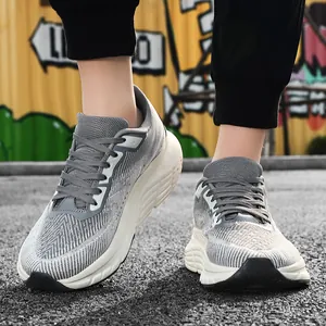 Detailed macro view of grey breathable knit running shoes featuring a wide-toe box design