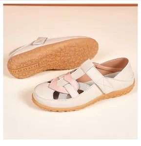 Detail of beige breathable flat sandals with braided design and flexible textured rubber sole.