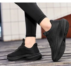Side view of black breathable mesh running shoes for women in an outdoor setting.