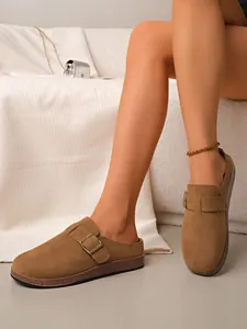 Close-up detail of women's vintage brown suede buckle clogs with comfortable cork sole