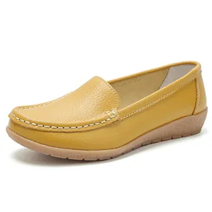 Comfortable mustard yellow women's flat loafers with soft sole and white stitching