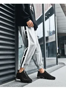 Detailed view of men's breathable fly-knit sneakers in a stylish urban setting