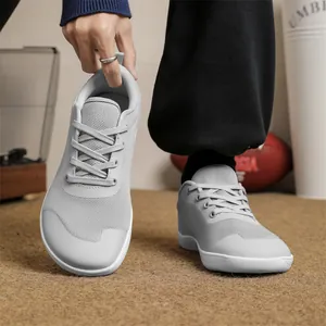 Detailed view of breathable knit barefoot shoes with wide toe box in light gray colors
