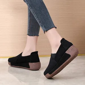 Comfortable women's black suede rocker shoes with thick brown textured platform sole