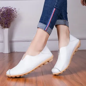 Stylish white leather flat loafers for women featuring a textured non-slip rubber sole
