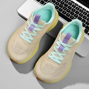 Detailed view of beige women's wide-toe running shoes with blue laces and yellow soles.