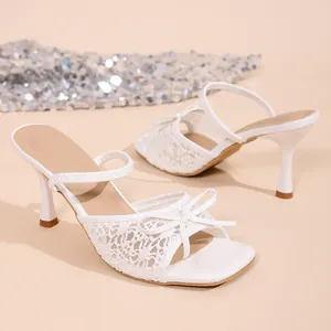 Elegant white lace high heel sandals with bow detail for summer