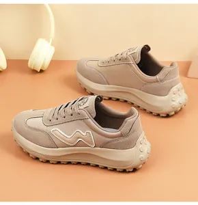 Detailed view of stylish beige women's platform sneakers with thick rubber soles