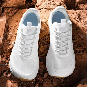 White wide-toe outdoor shoes for men shown on a cracked desert earth background