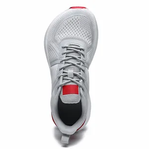 Top view of grey breathable mesh running shoes with wide toe box and red accents.