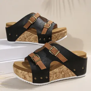 Detailed view of women black and brown cork wedge sandals with adjustable buckle straps