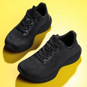 Close-up of black carbon plate running shoes with breathable fly-knit mesh on yellow ground.