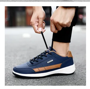 Close-up detail of blue waterproof leather sports sneakers for men with brown accent stripes