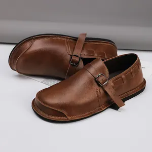 Detailed view of retro brown leather shoes with wide toe box and buckle design