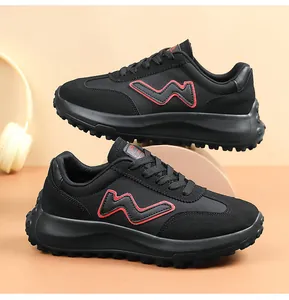 Detailed view of stylish black platform running shoes with red wave logo and studded sole