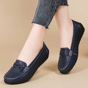 Stylish navy blue women's loafers featuring contrast stitching and a comfortable flat sole
