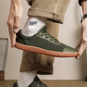Detailed view of breathable army green fly-knit barefoot shoes with wide toe box design.