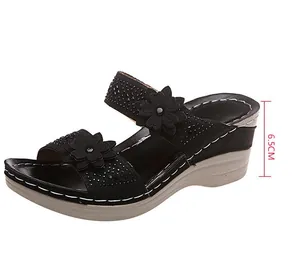 Detailed side view of black floral wedge sandal with a 6.5cm heel height marker