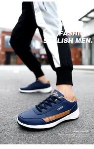 Close-up view of blue and brown men's outdoor running shoes with leather texture.