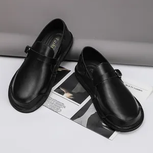 Detail view of black vintage leather men's shoes with wide-toe design and buckle strap