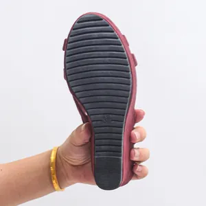 Detailed view showing the non-slip rubber sole of a stylish women's wedge sandal