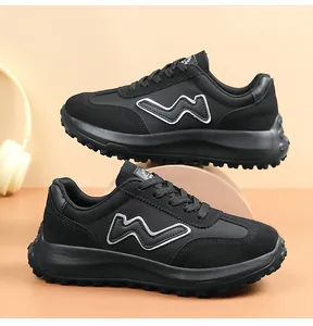 Side view profile of black thick-soled women's casual sneakers with a white W logo