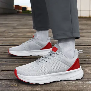 Breathable grey mesh men's athletic sneakers with red accents and wide white sole