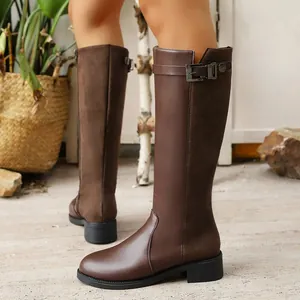 Side view of brown knee-high riding boots featuring leather and suede splicing details