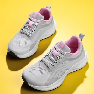 Detail view of grey mesh running shoes for women with pink accents and wide toe box