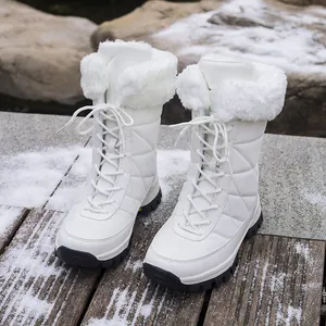 Warm white mid-calf women's snow boots featuring faux fur trim and durable lace-up design