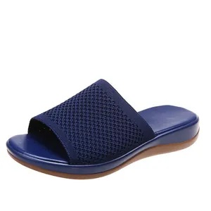 Detail shot of the navy blue fly-woven upper and comfortable polyurethane wedge sole