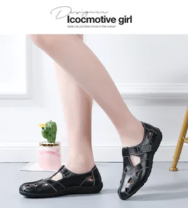 Close-up view of elegant black hollow-out genuine leather flat sandals for women